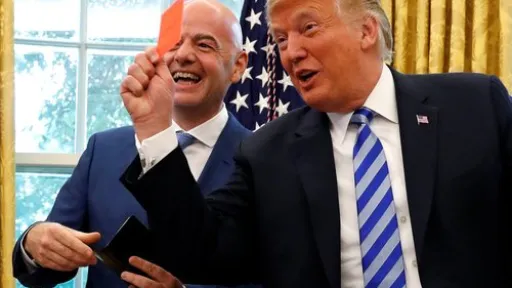 FILE PHOTO: U.S. President Donald Trump holds up a red card as he meets with FIFA President Gianni Infantino in the Oval Office of the White House in Washington, U.S., August 28, 2018. REUTERS/Leah Millis/File Photo