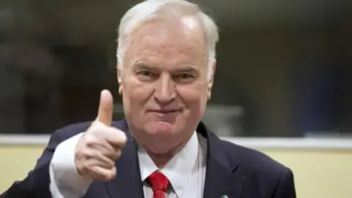 Getty Images An unrepentant Mladić gives a thumbs-up at his trial at the International Court of Justice at the Hague